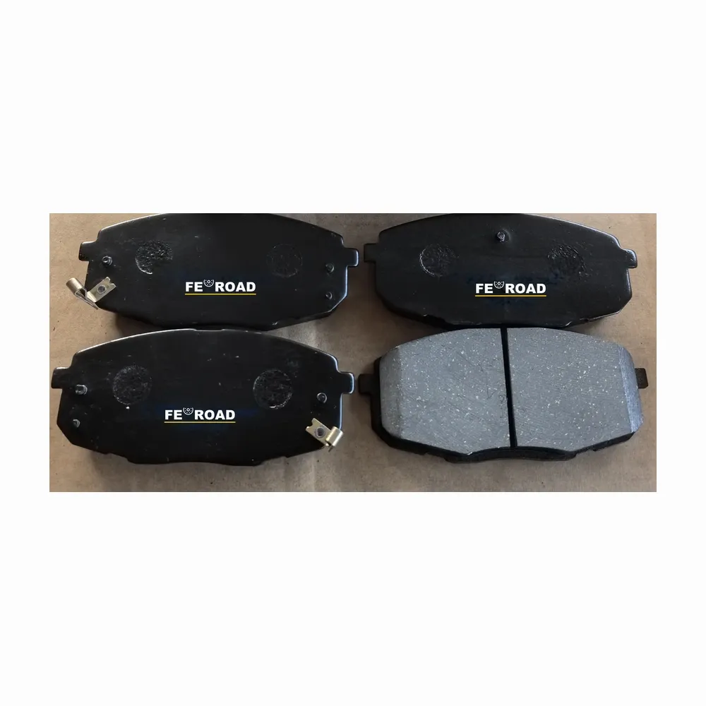 Brake pad set with standard backing and locating holes