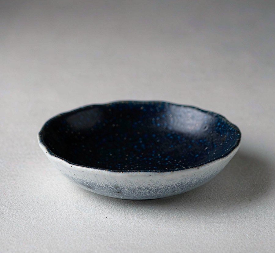 Small bowl with navy glazed interior and wavy rim