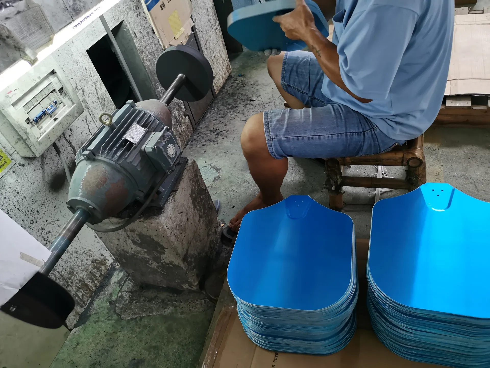 Worker carrying out surface finishing on pizza peel heads