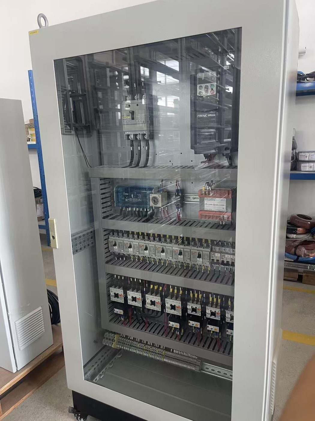 PLC control panel with glass door and wired terminal rows