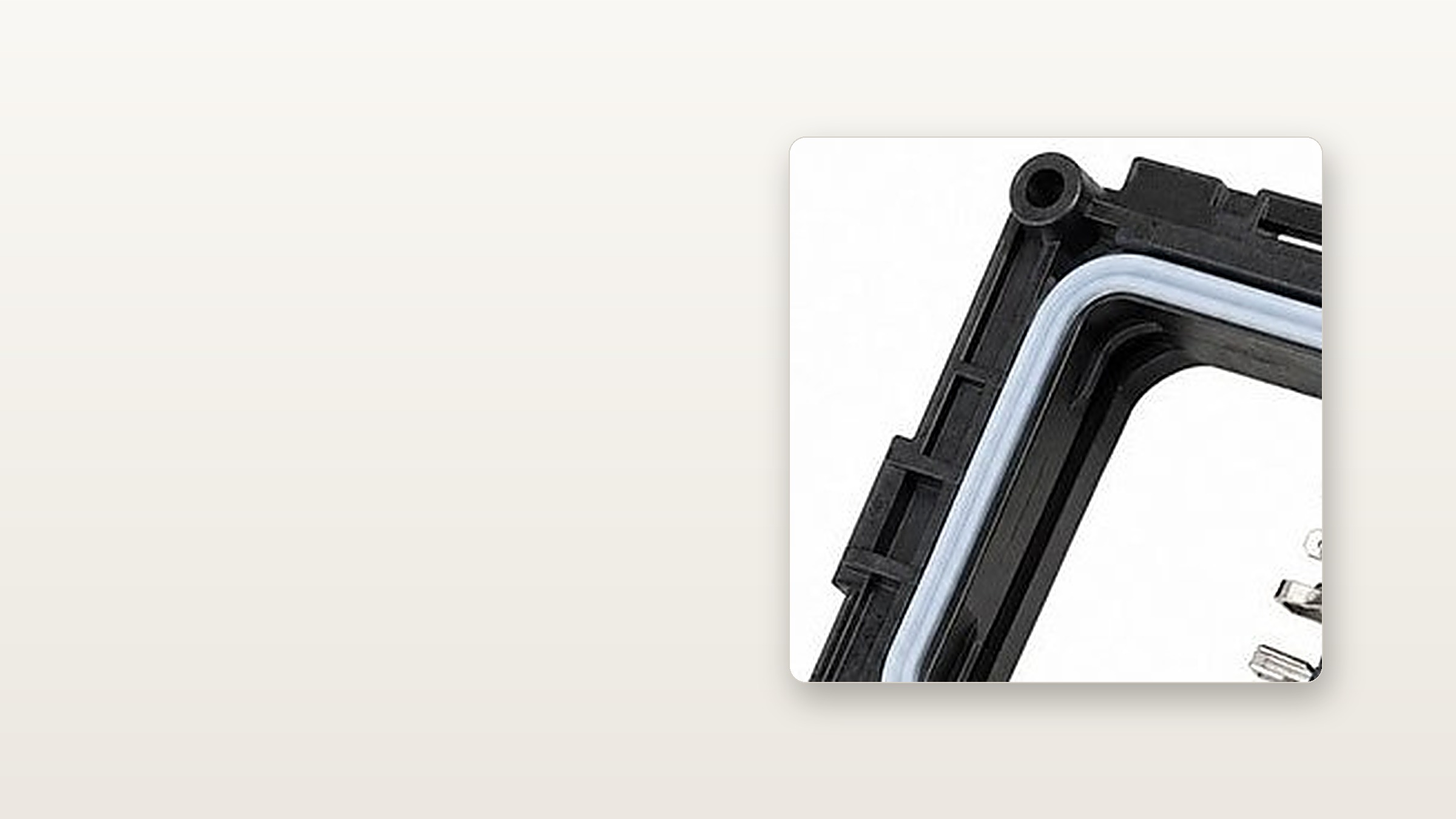 Black LSR waterproof button housing with light grey seal, presented as the visual focus on a warm white background