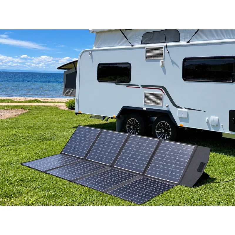 sewn foldable panel propped beside a camper trailer at a beach campsite