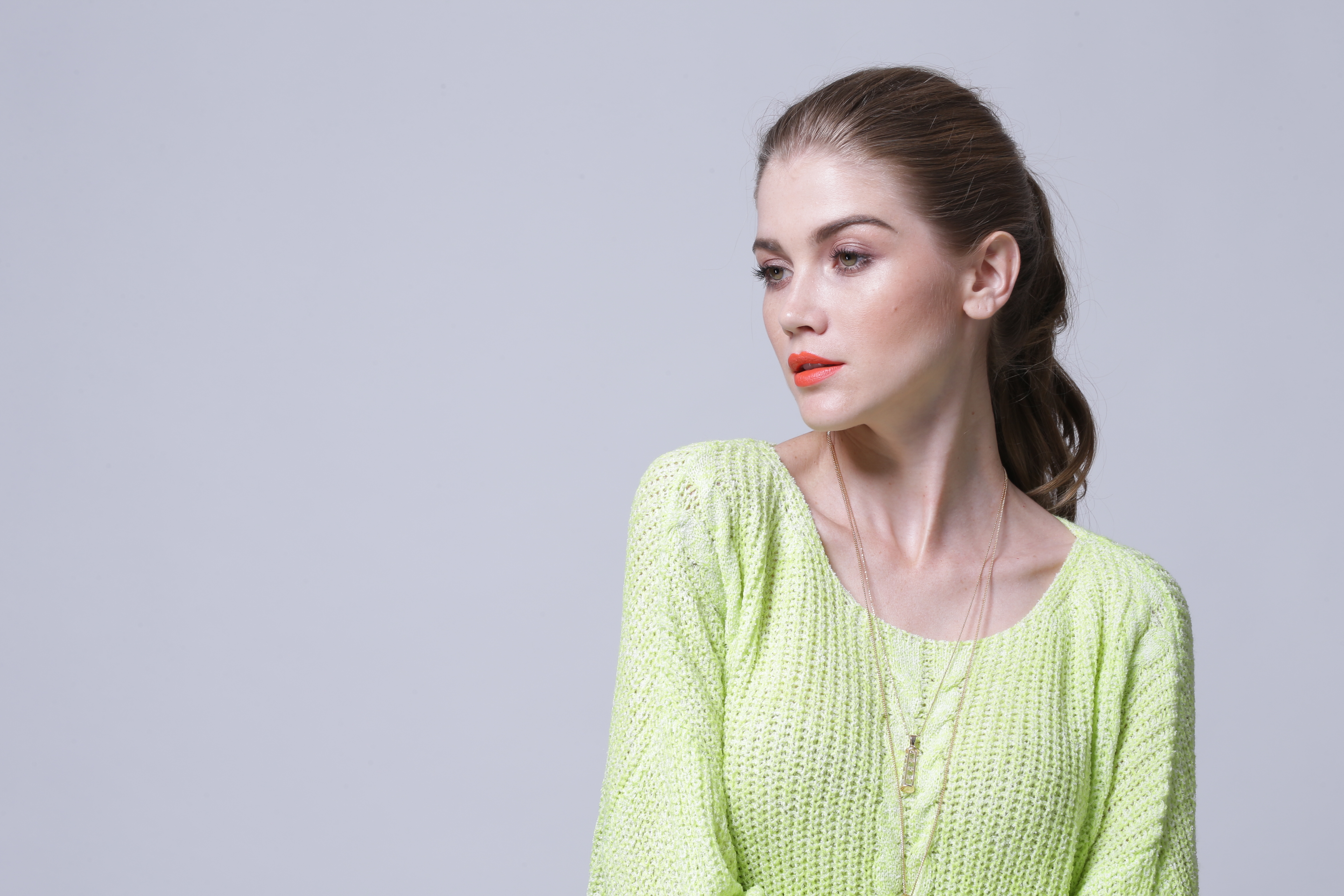 Women's soft knitted pullover IMP109 edge trim and seam joinery detail under studio illumination