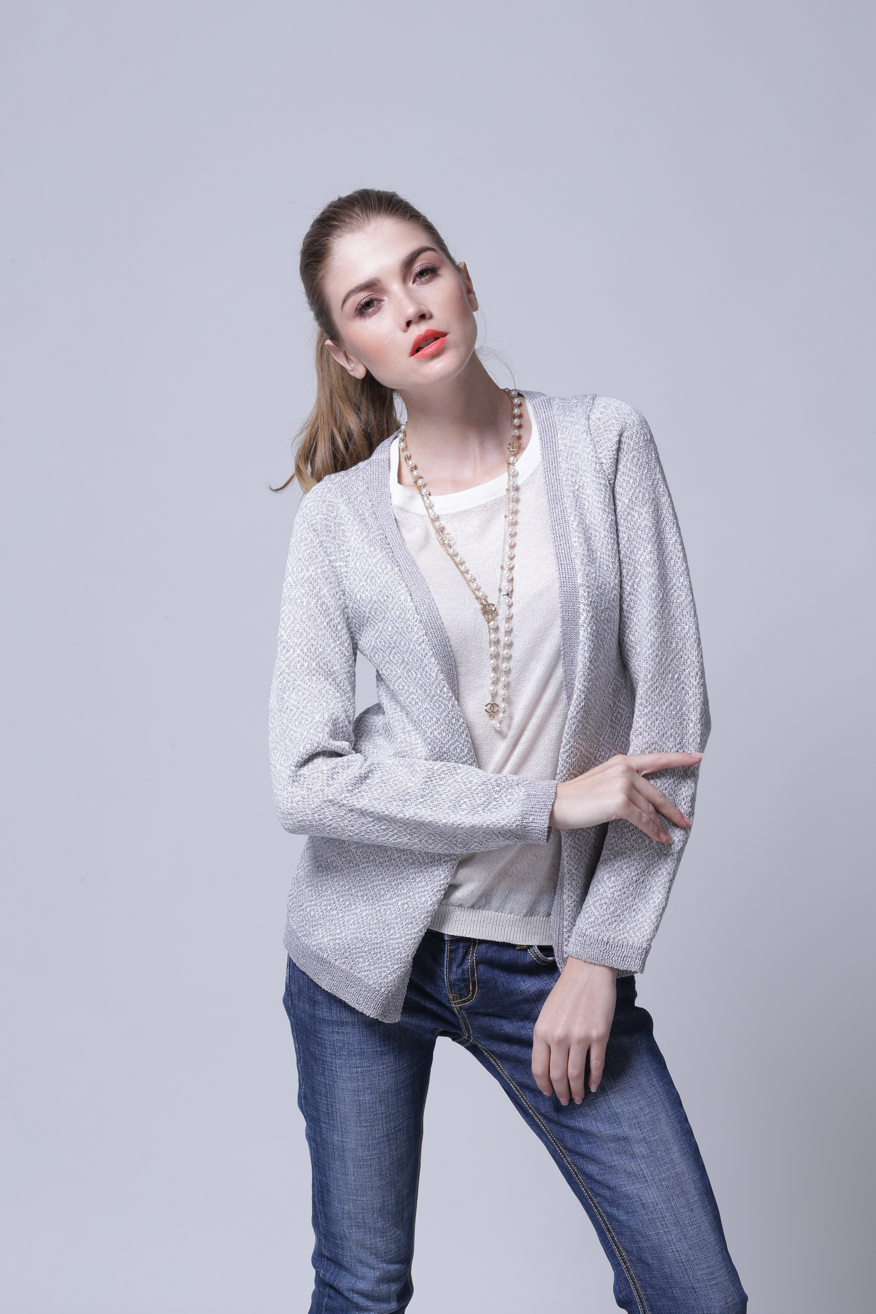 Back perspective highlighting neat shoulder construction of women's cardigan IMC109