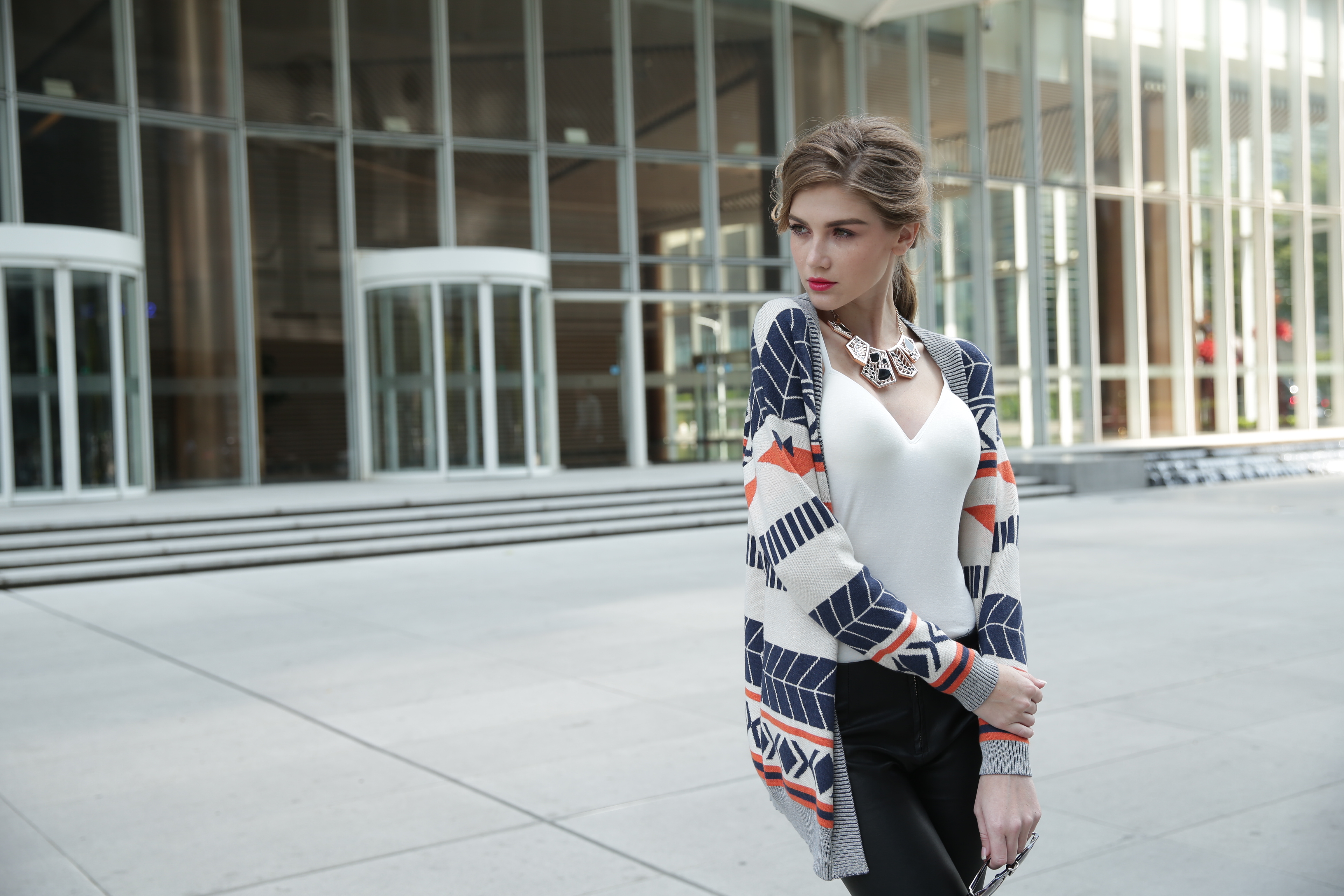 Three-quarter angle studio view of women's knitted cardigan IMC113 designed for modern layering