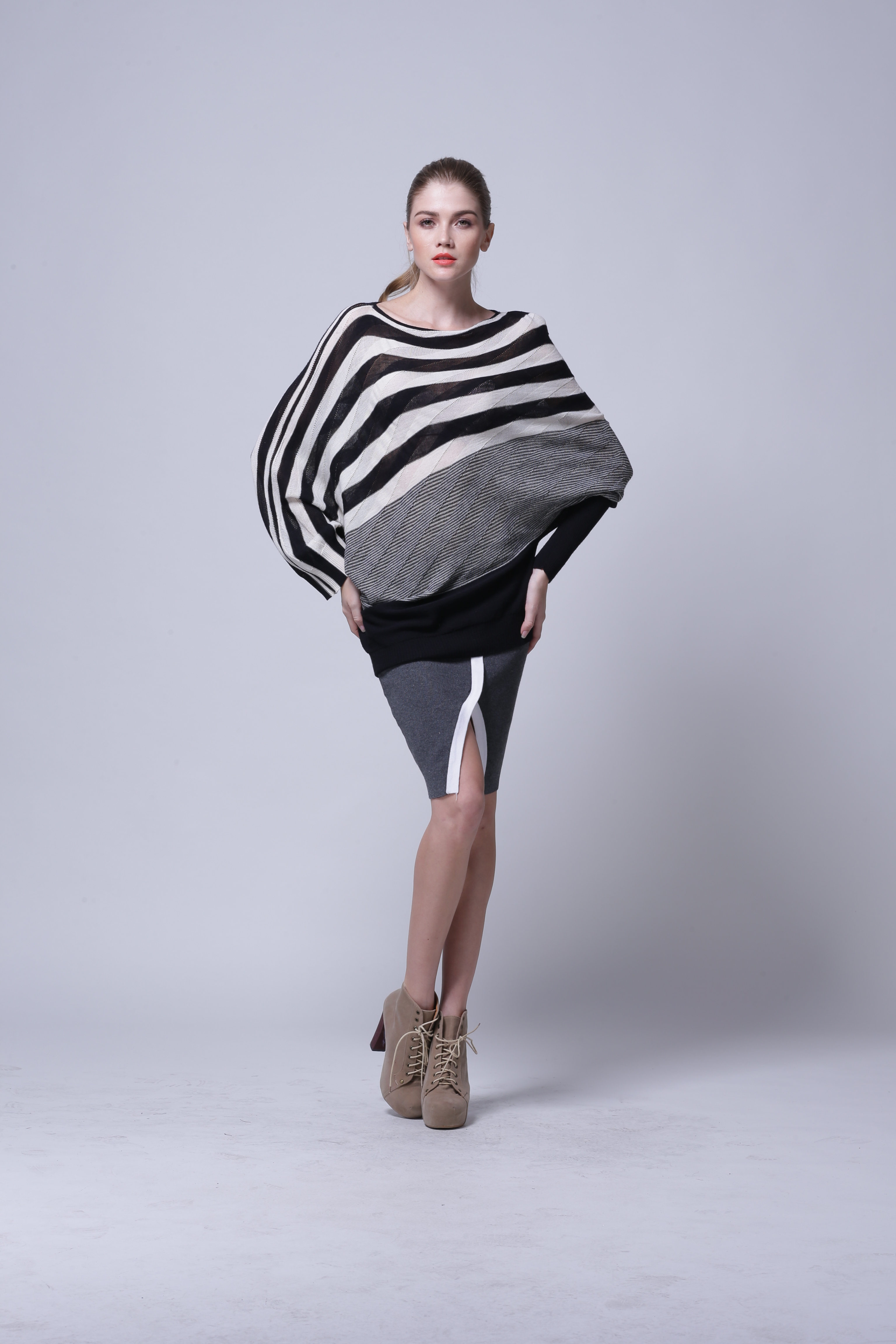 Side angle profile of women's knitted pullover IMP117 highlighting balanced drape