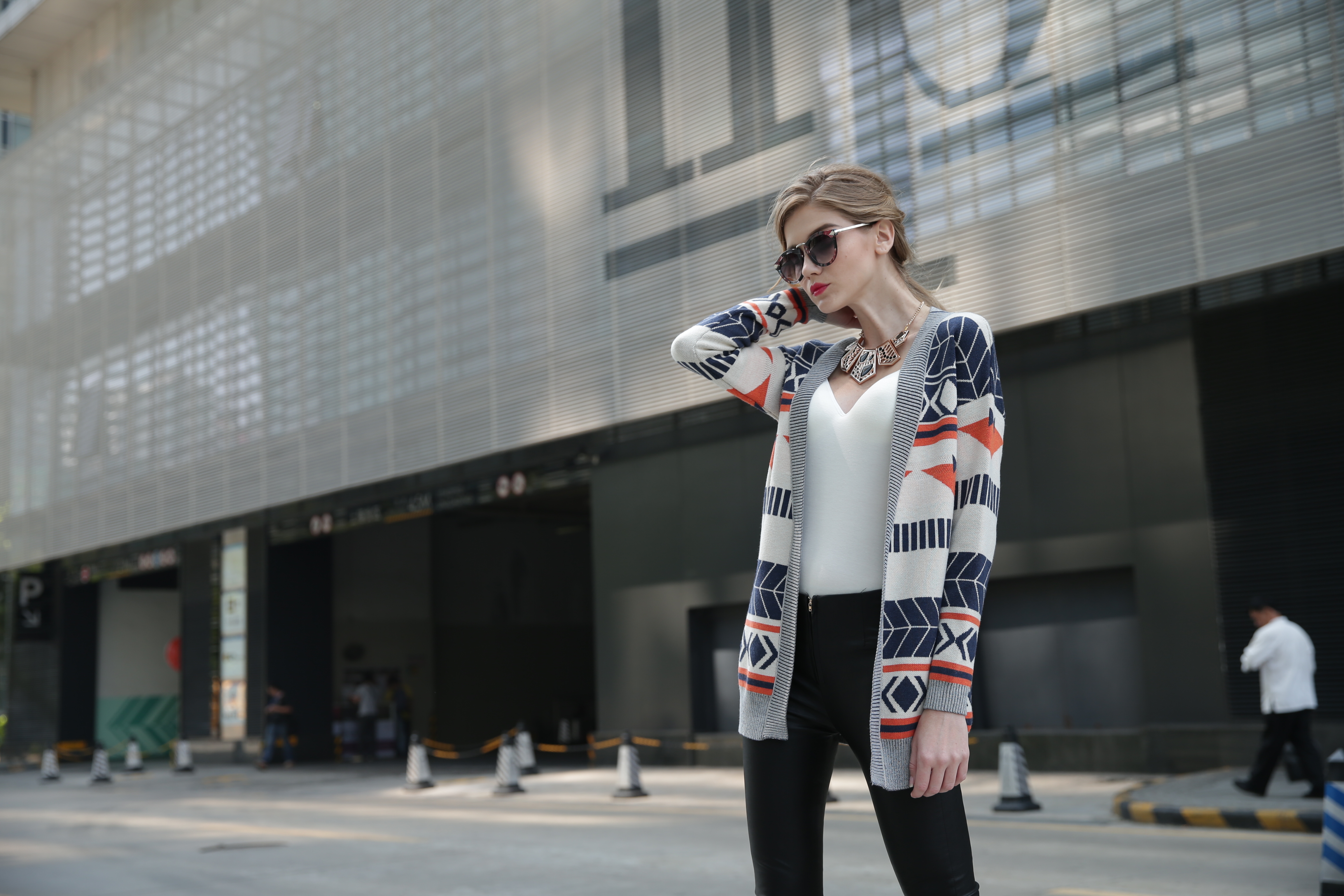 Back perspective of women's knitted cardigan IMC113 displaying balanced knitwear proportions