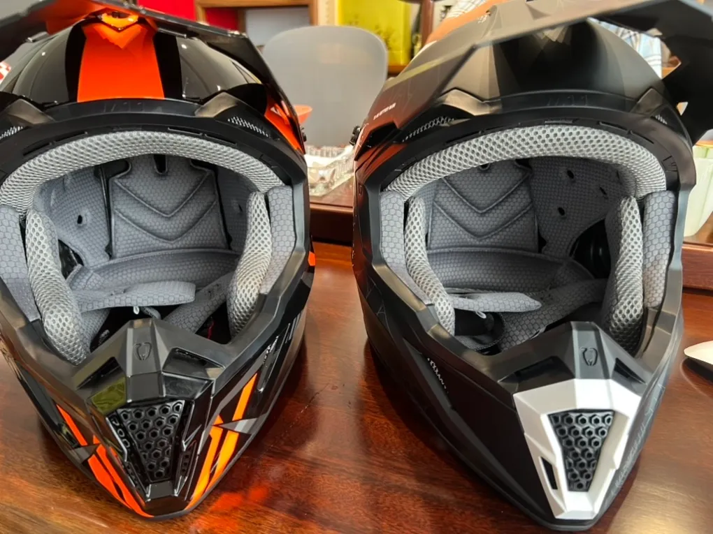 Interior view of two off-road motocross helmets from our range showing chin straps, liners and mouth vents