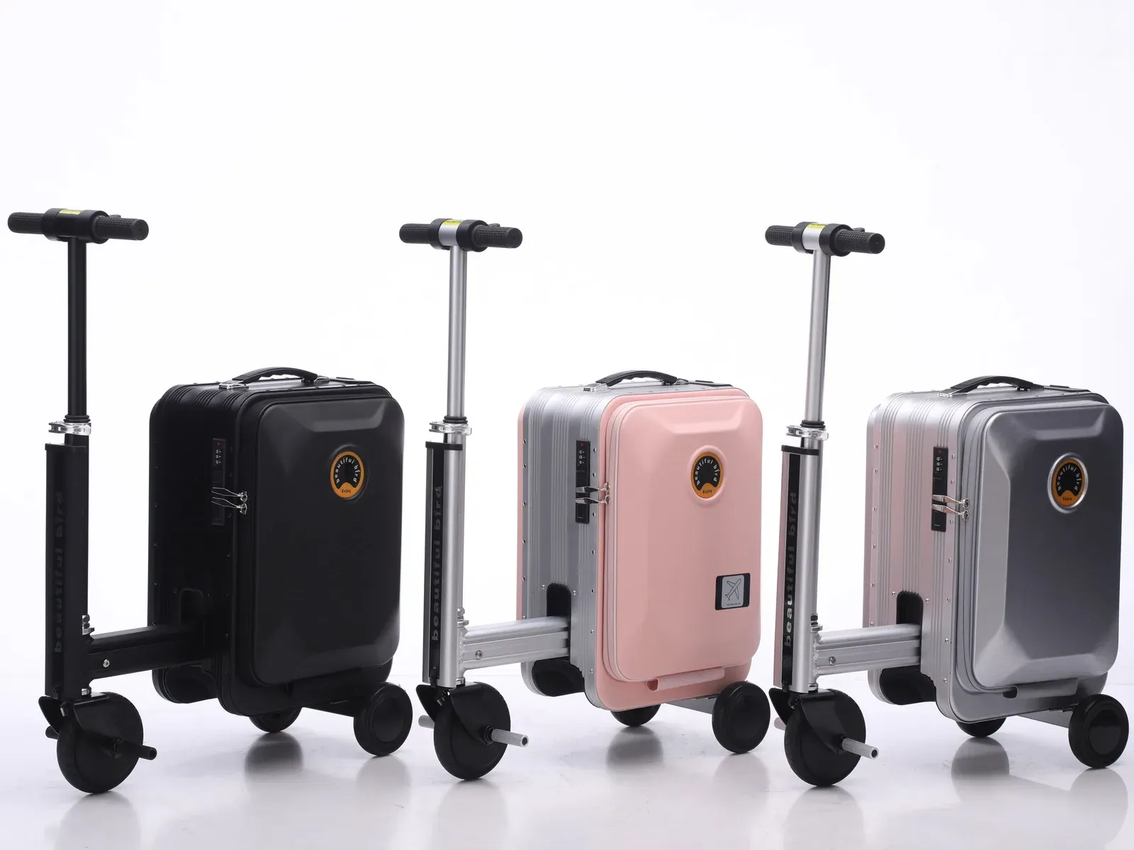 Three beautiful bird 666 ride-on electric suitcases photographed in a studio, each in ride-on position with the telescopic footrest rail extended