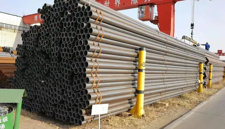 Large diameter welded steel pipe stack with lifting rig at yard