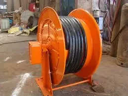 Spring driven hose and cable reel with sliding ring power supply