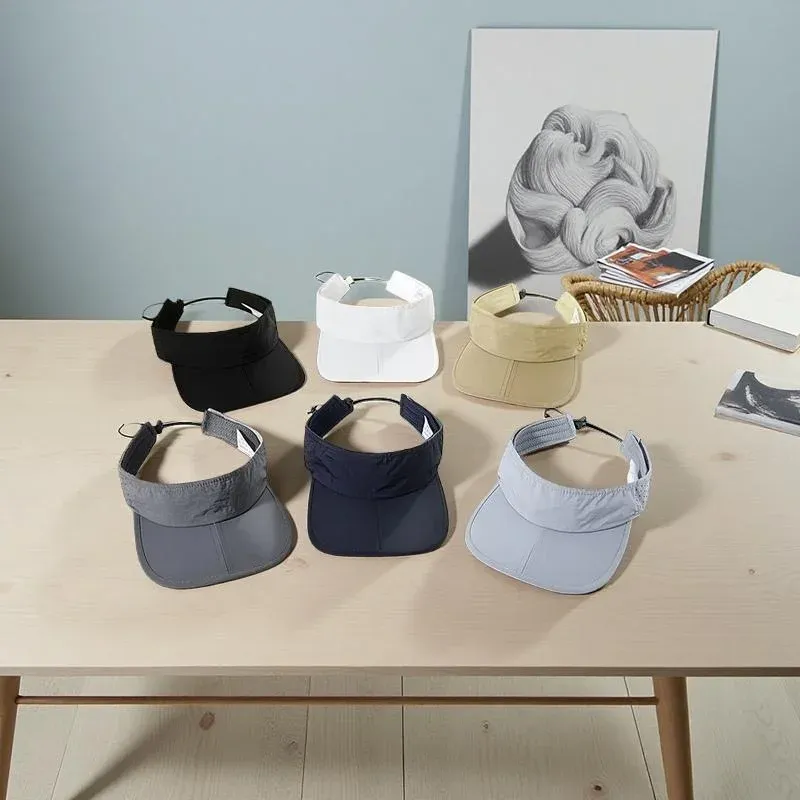 Six nylon running visors in multiple colors with elastic closures on a table