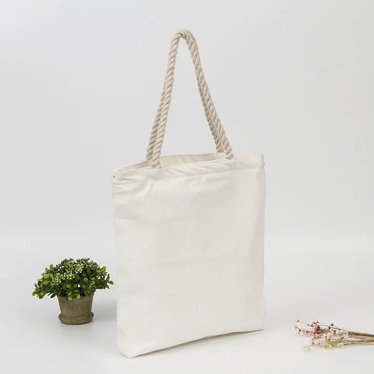 Ivory cotton tote bag with twisted rope handles, angled standing view