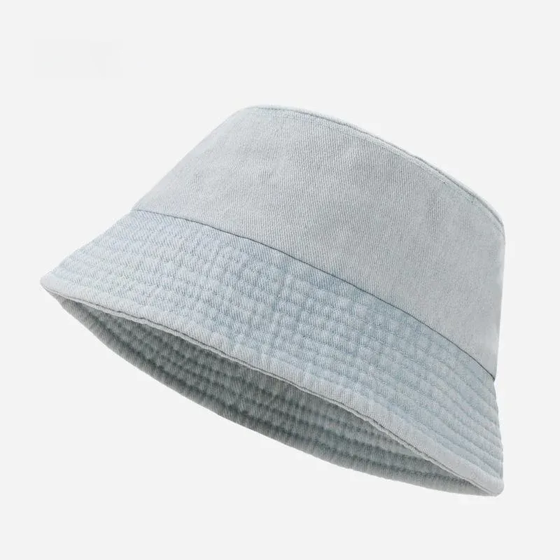 Pale blue washed cotton denim bucket hat with quilted stitched brim, angled view
