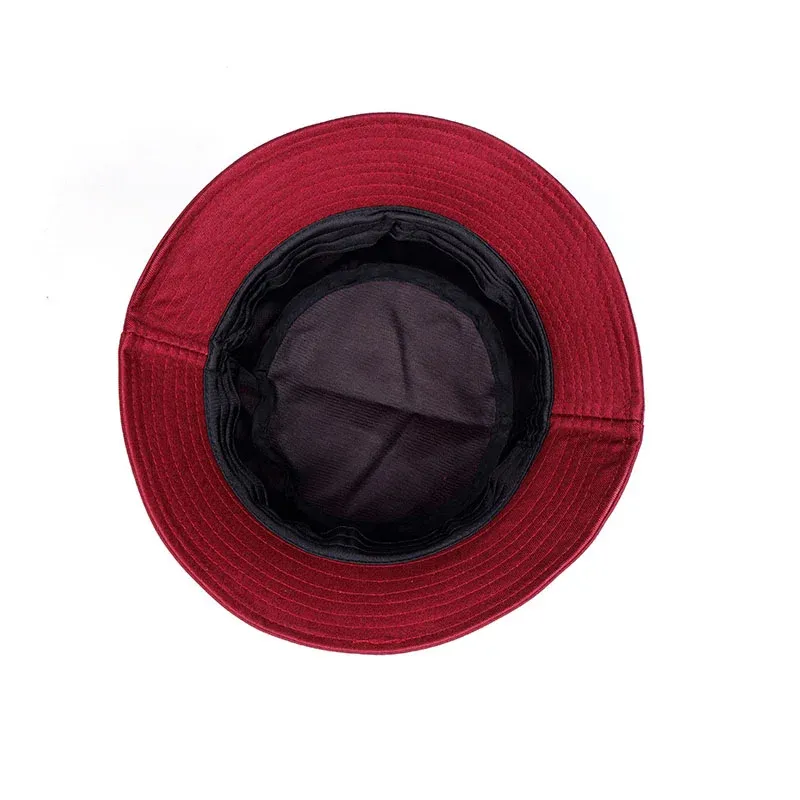 Burgundy cotton bucket hat viewed from above showing the black inner lining and stitched brim