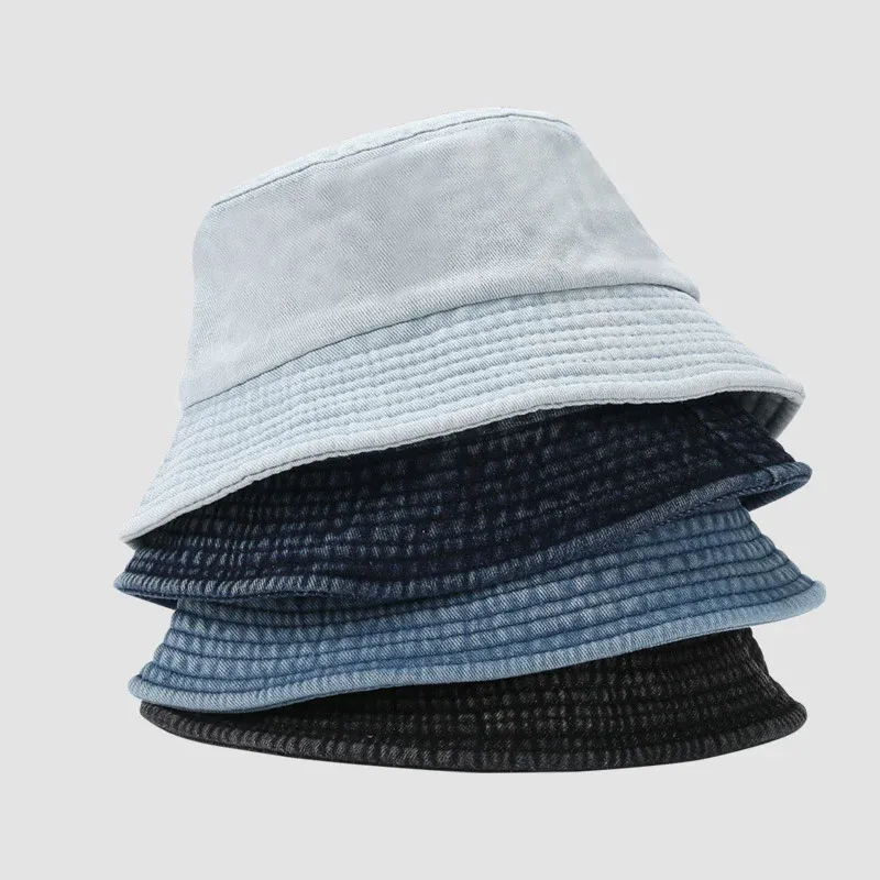 Stack of four cotton denim bucket hats in light blue, dark navy, mid blue and black