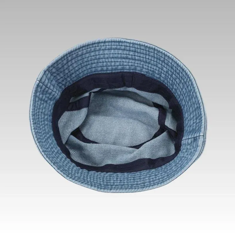 Light blue cotton denim bucket hat viewed from above showing the navy inner band and denim brim stitching