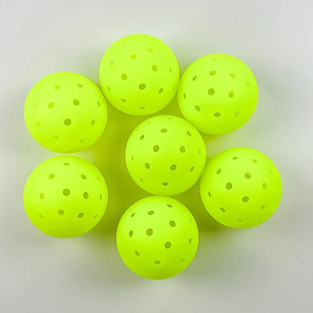 Seven lime pickleballs overhead view