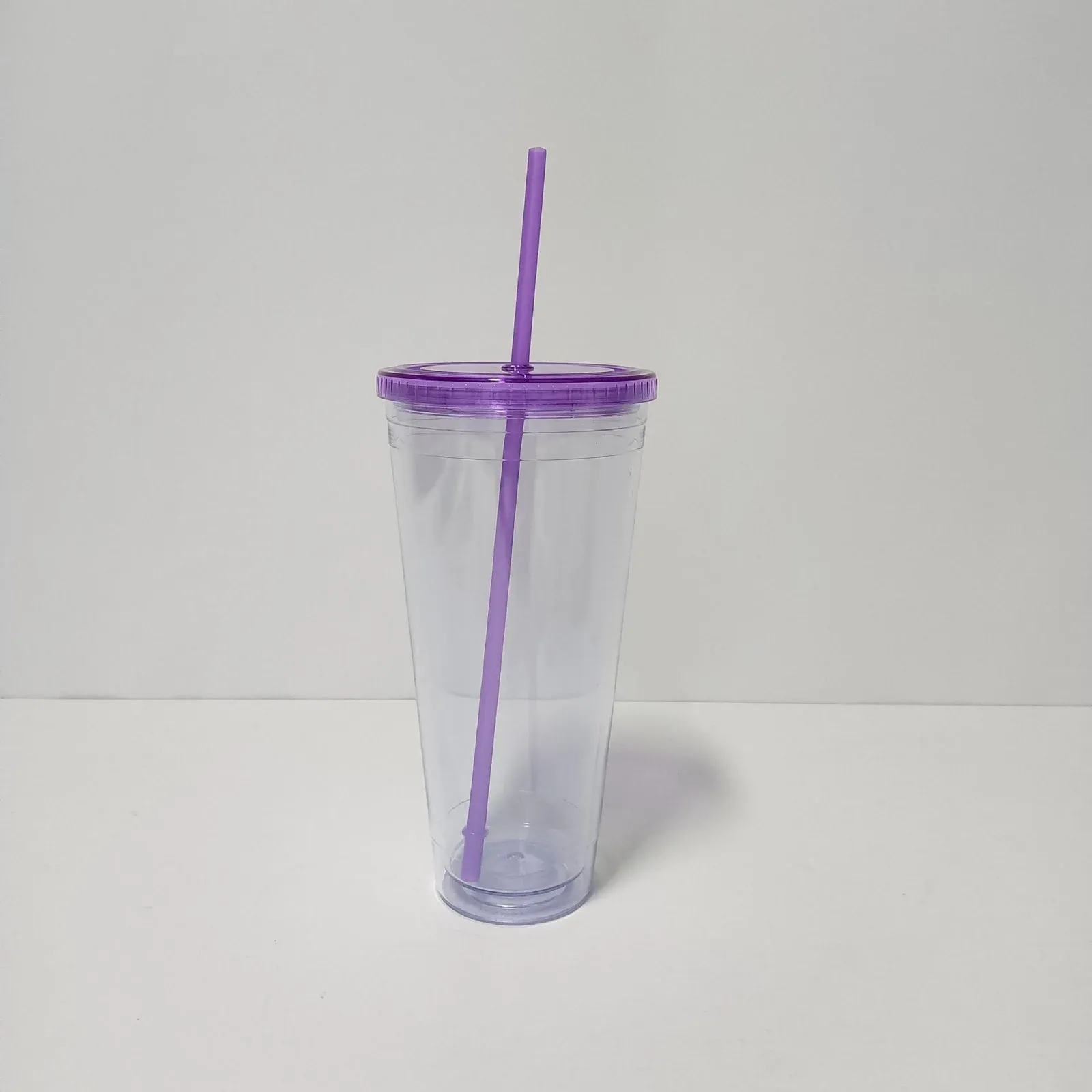 Clear double-wall plastic tumbler with translucent purple lid and purple straw, no handle