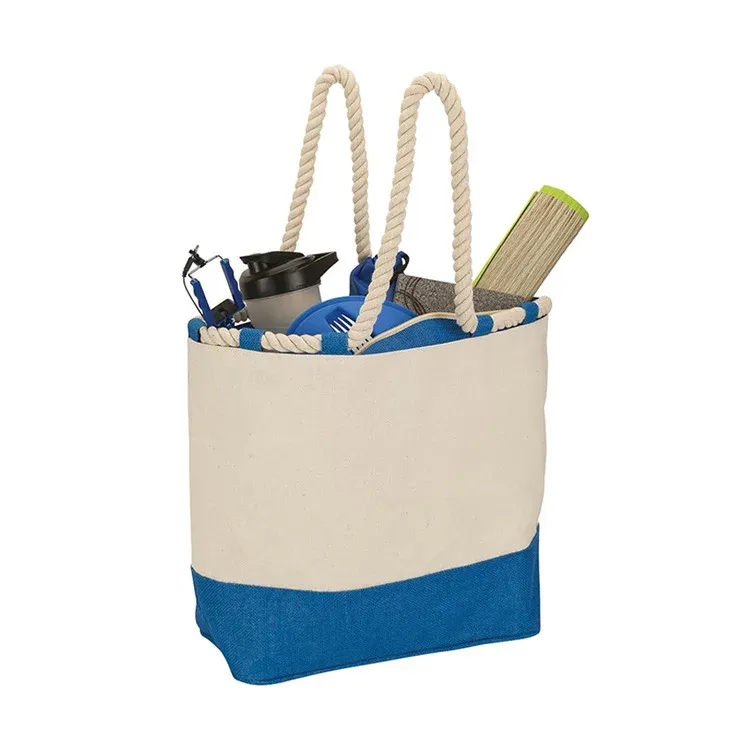 Cream boat tote with rope handles and a blue contrast base filled with personal items, unprinted front view
