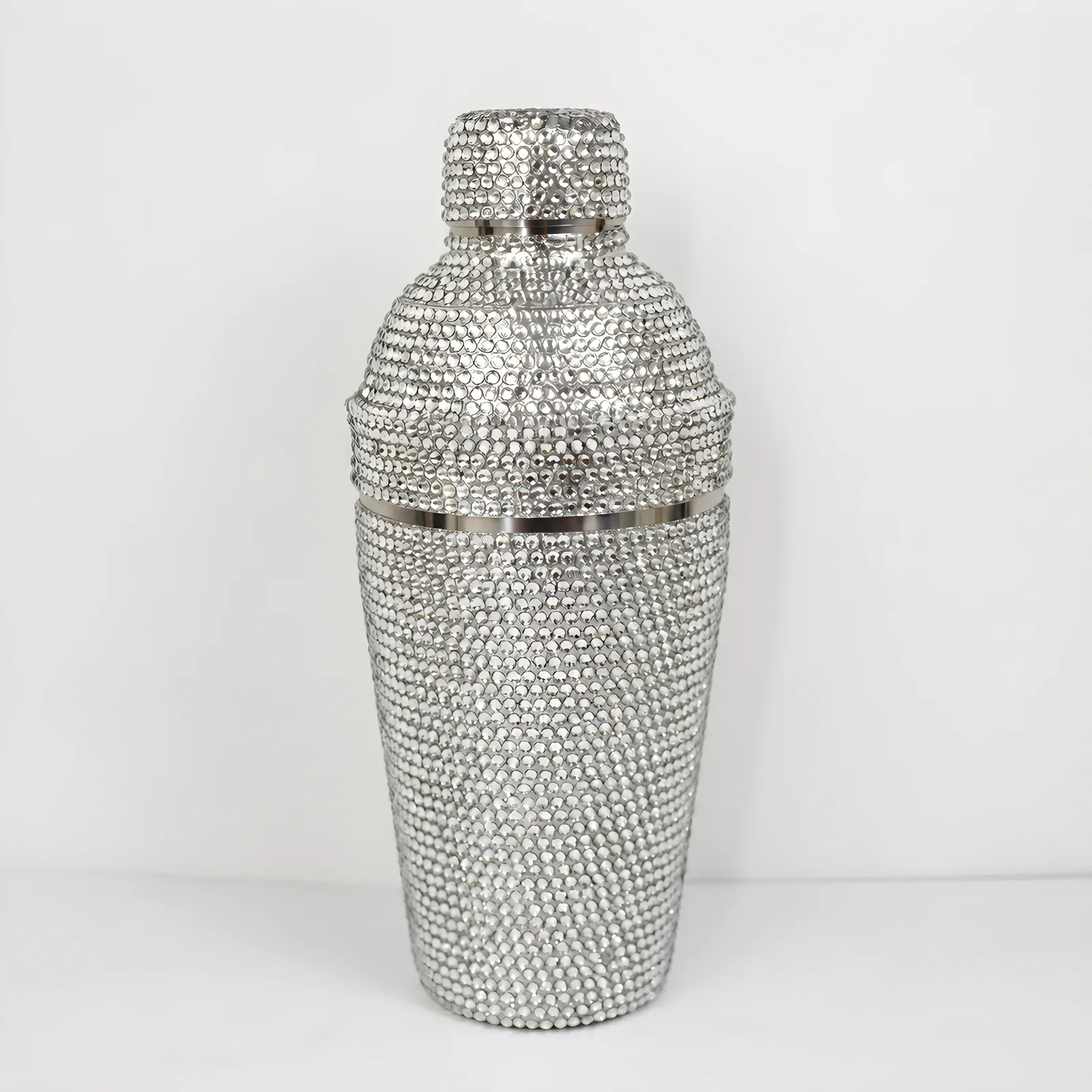 Cocktail shaker fully covered in clear crystal rhinestones on a white background