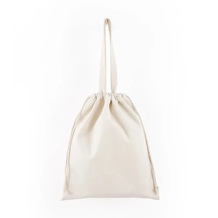 Natural canvas drawstring tote cinched shut by its top drawstring, hanging view