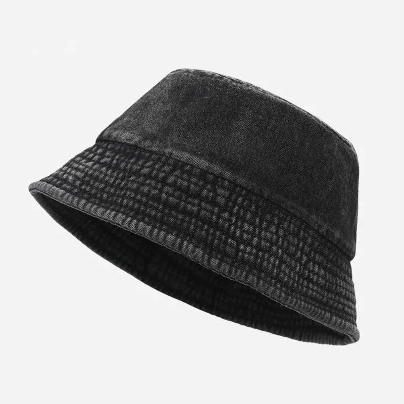 Black washed cotton denim bucket hat with quilted stitched brim, angled view