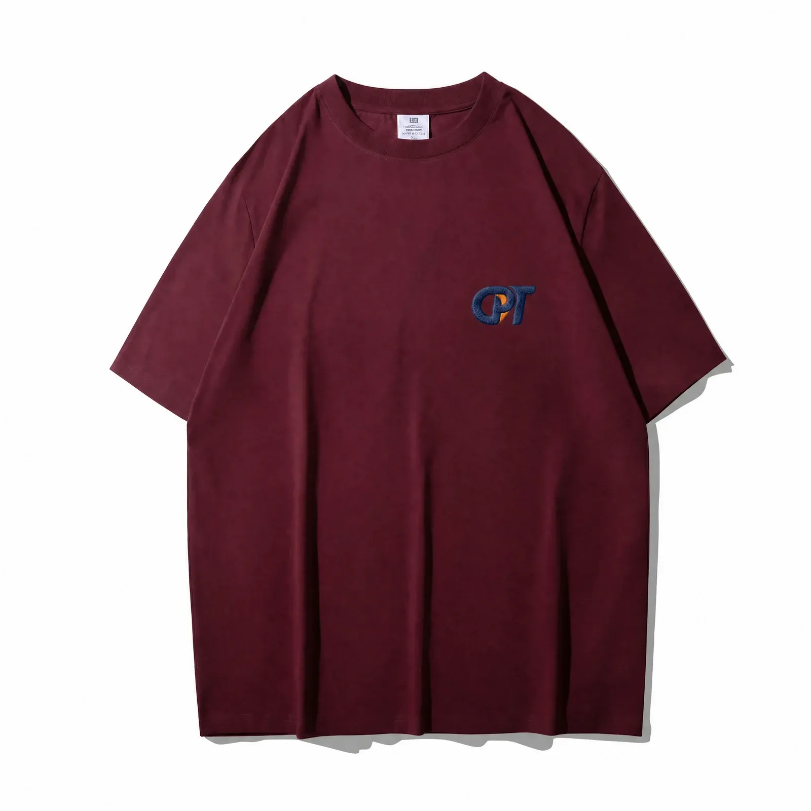 Burgundy drop shoulder t-shirt with embroidered chest logo, front view