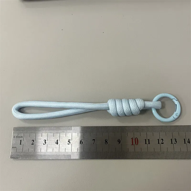 Light blue solid rope phone wrist strap beside ruler