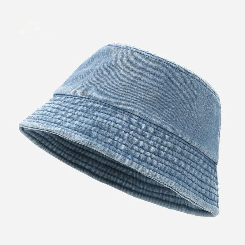 Light blue cotton denim bucket hat with washed texture and quilted stitched brim, angled view
