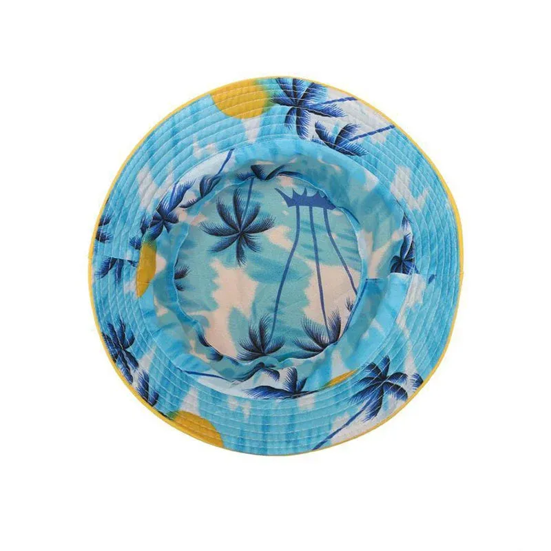 Top view of a bucket hat with an all-over tropical palm print and solid yellow brim edge showing the two-sided construction