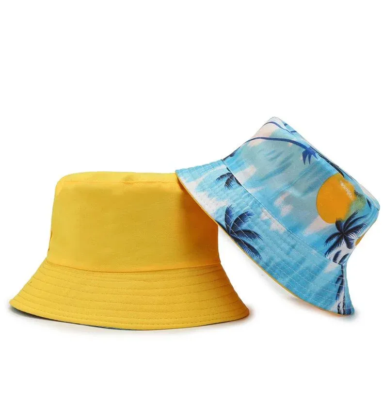Two bucket hats side by side, one solid yellow and one light blue with an all-over tropical palm tree print