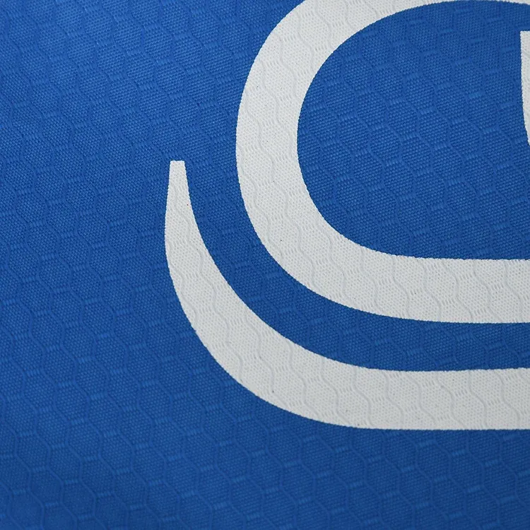 Macro detail of the white OPT logo print on royal blue honeycomb embossed 420D polyester