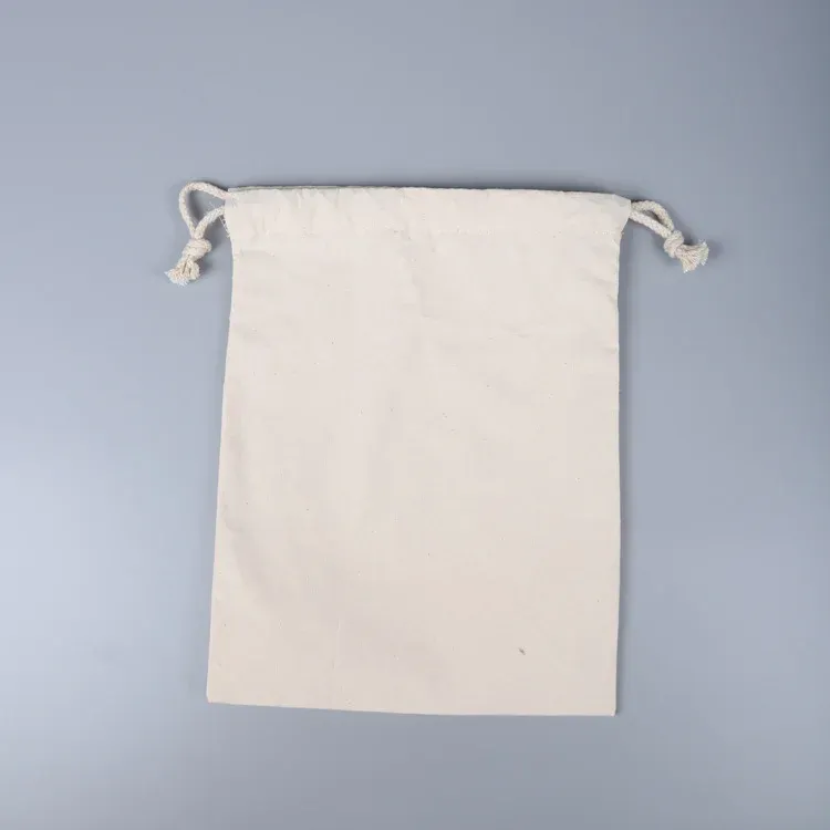 Single flat natural canvas drawstring pouch, top-down flat lay with knotted cotton cords