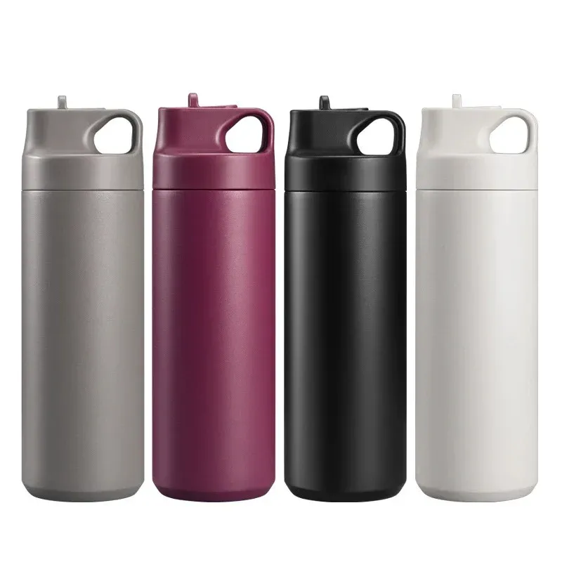 Four minimalist 500ml stainless steel water bottles in gray, burgundy, black and white with integrated loop-handle spout lids, lined up in a row