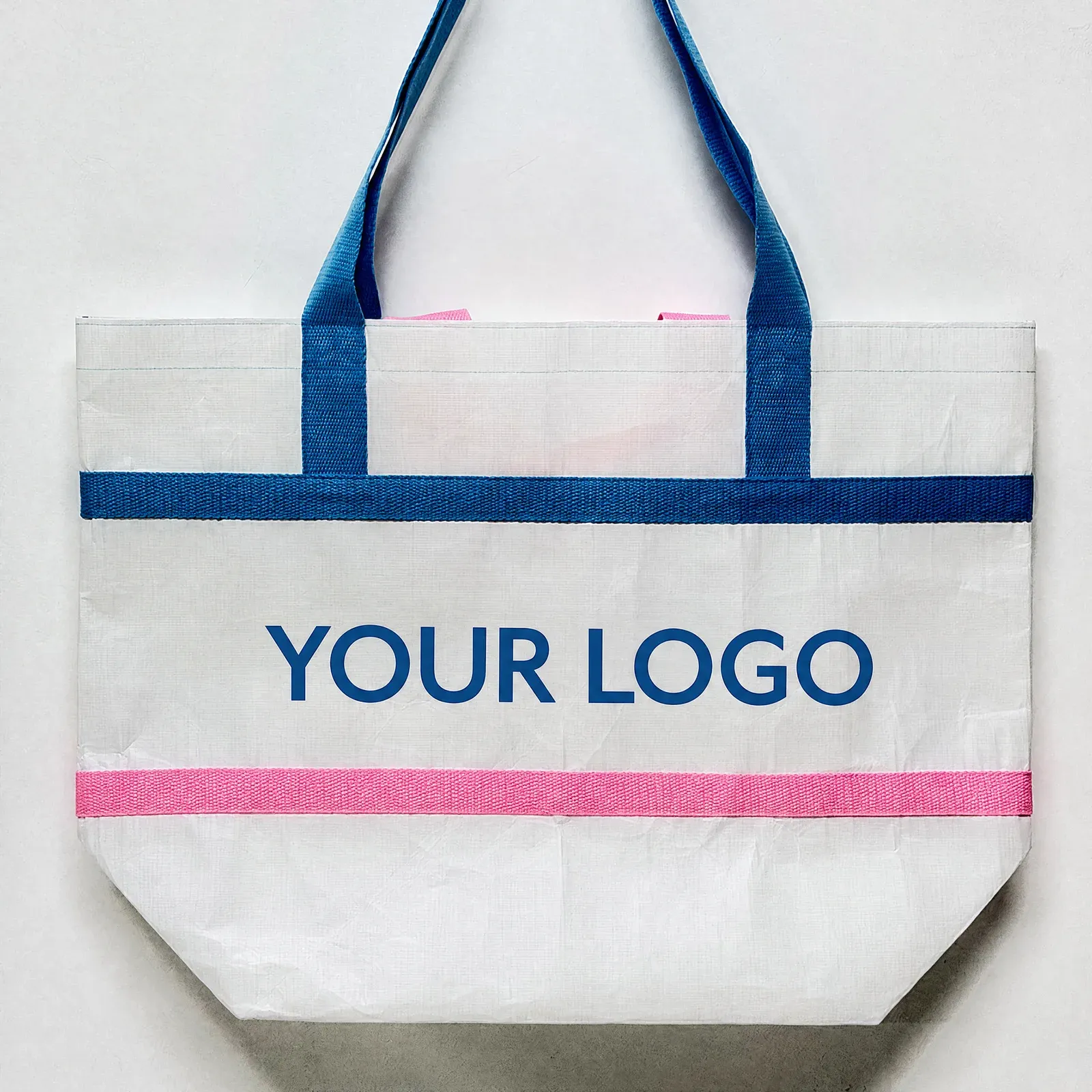 Front view of the blue and pink contrast trim RPET tote with logo print