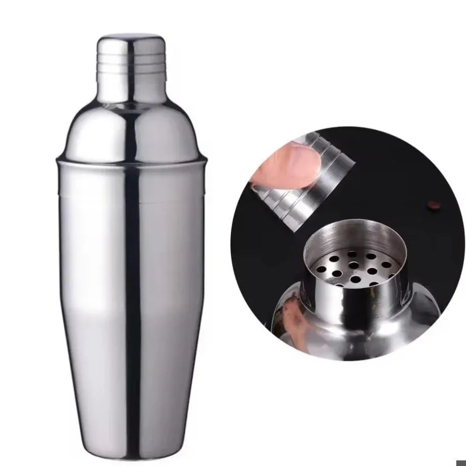 Stainless steel cocktail shaker with a close-up inset showing the perforated strainer top and cap being lifted