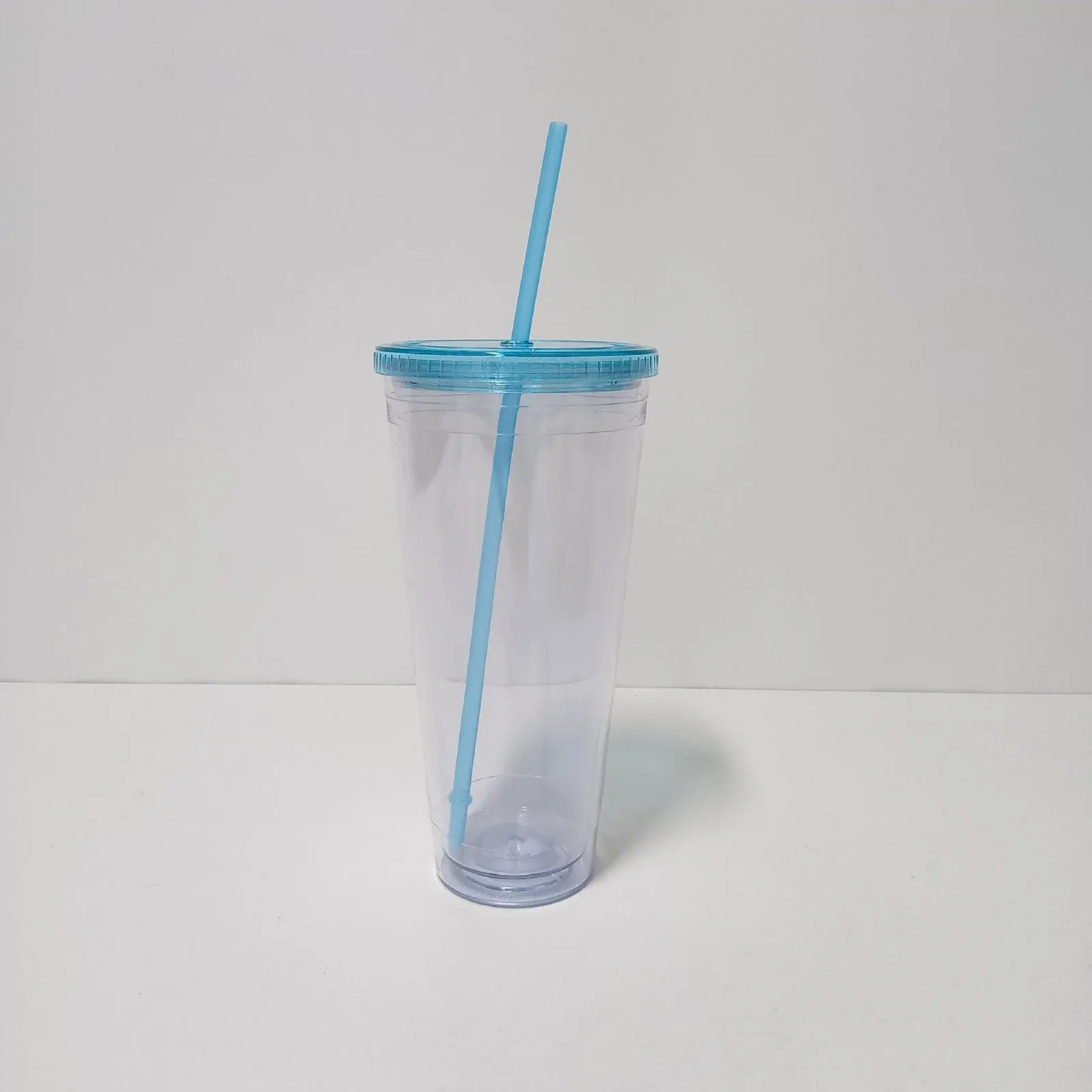 Clear double-wall plastic tumbler with translucent blue lid and blue straw, no handle