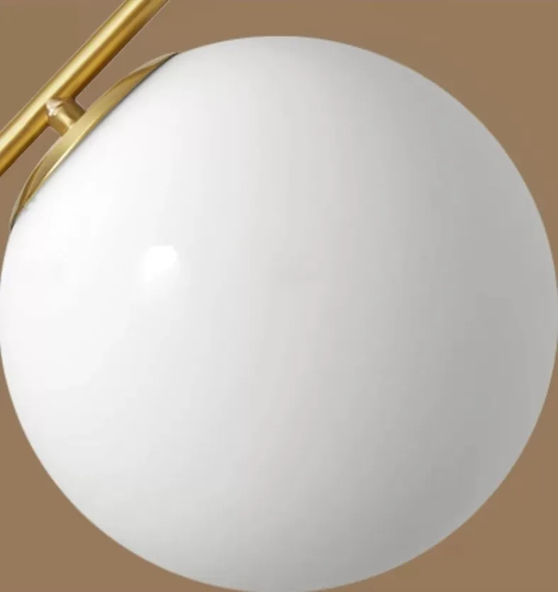 SPP-2602 pendant light showing the white spherical glass shade and brass-finished metal connection.