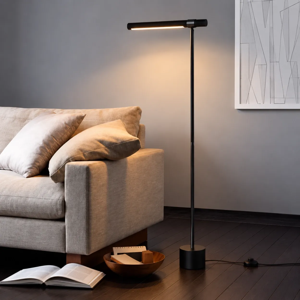 SPF-2607 matte black linear floor lamp with warm lighting and cylindrical base beside a sofa in a modern living room