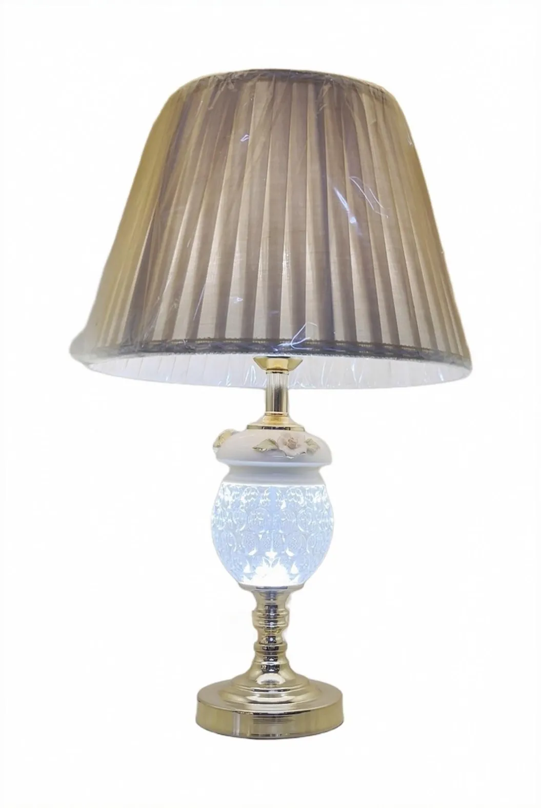 Classic table lamp with a pleated white shade, floral ceramic body and gold-tone turned stem