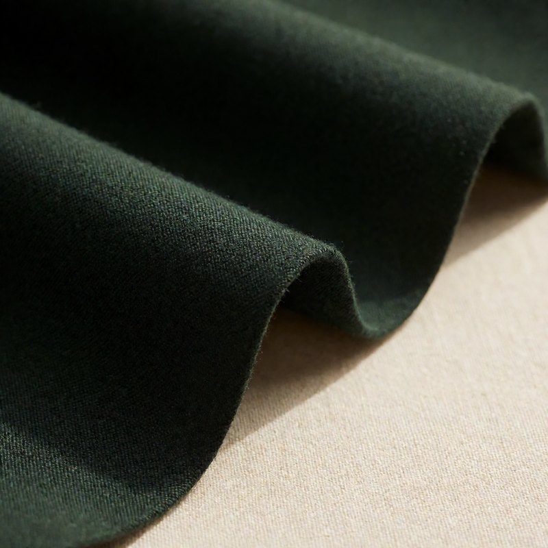 Macro of deep army green wool suiting fabric