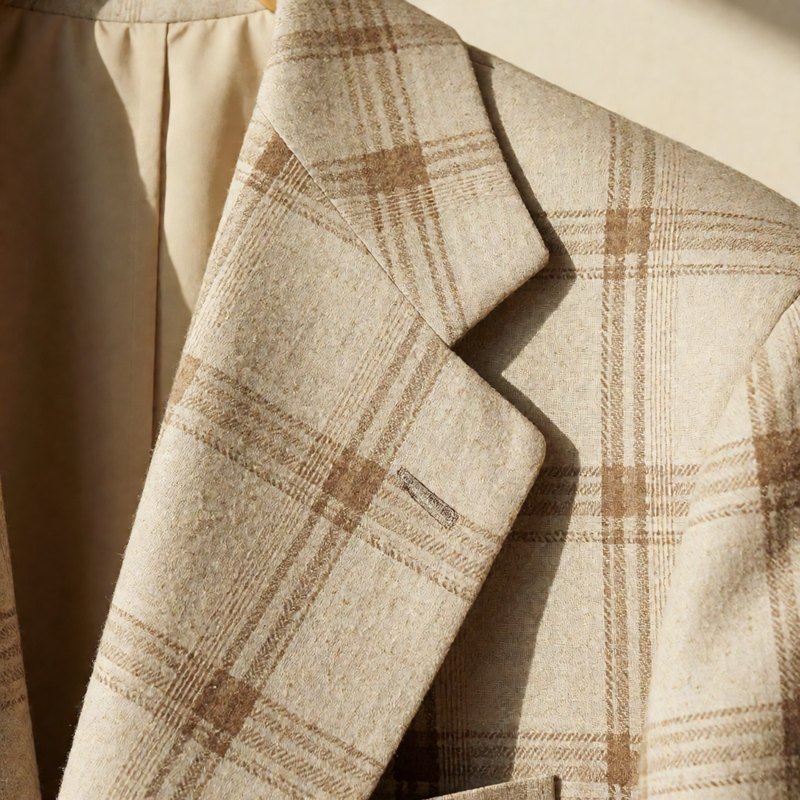 Close-up of the peak lapel with subtle tonal check in the weave