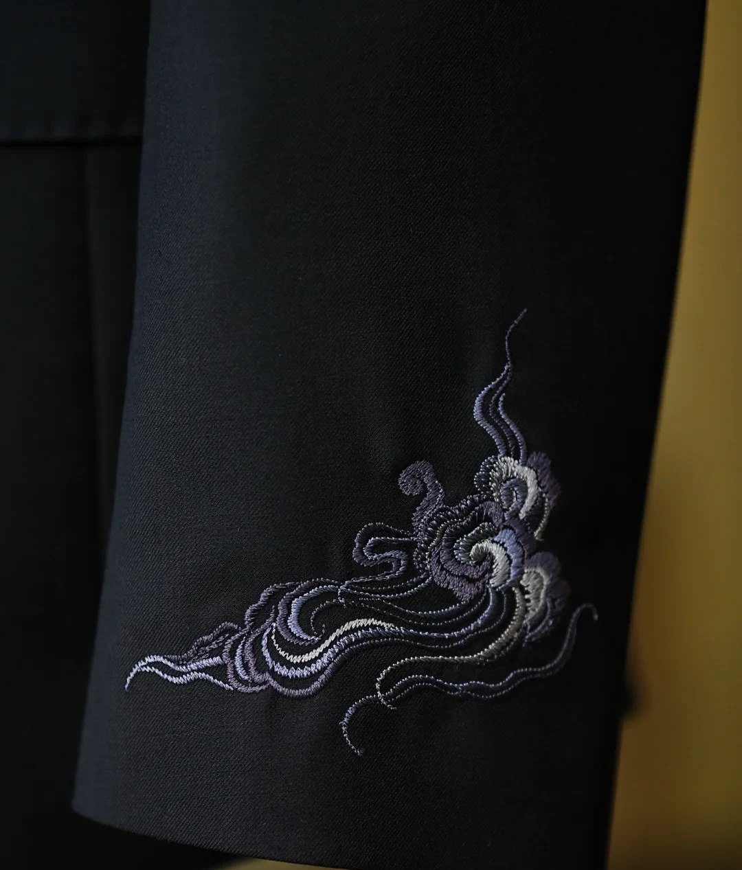 Tone-on-tone embroidery on navy suit