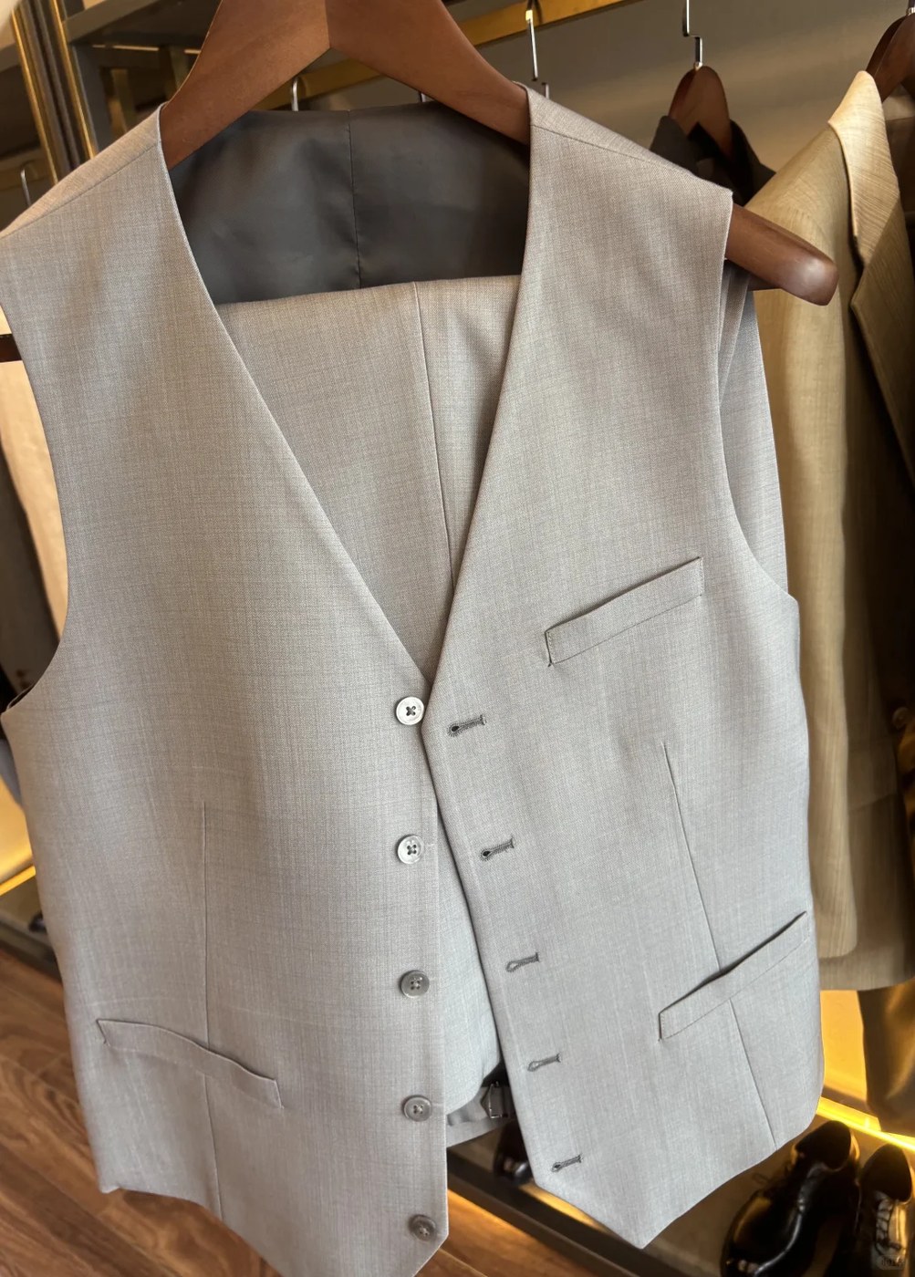 Cream suit waistcoat on wooden hanger