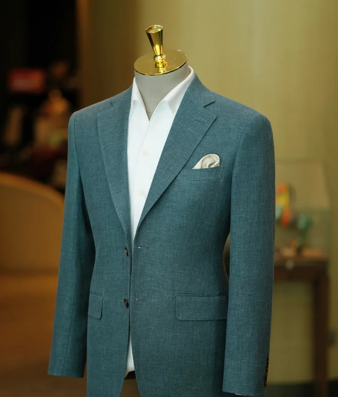 Teal double-breasted blazer with white shirt on mannequin