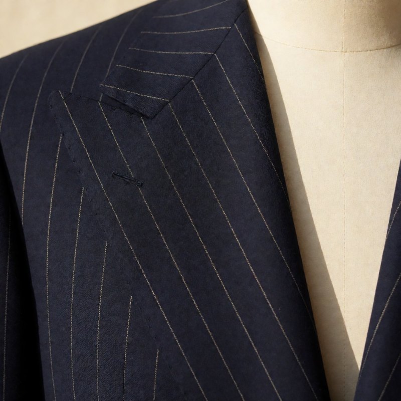 Close-up of the peak lapel with champagne pinstripes