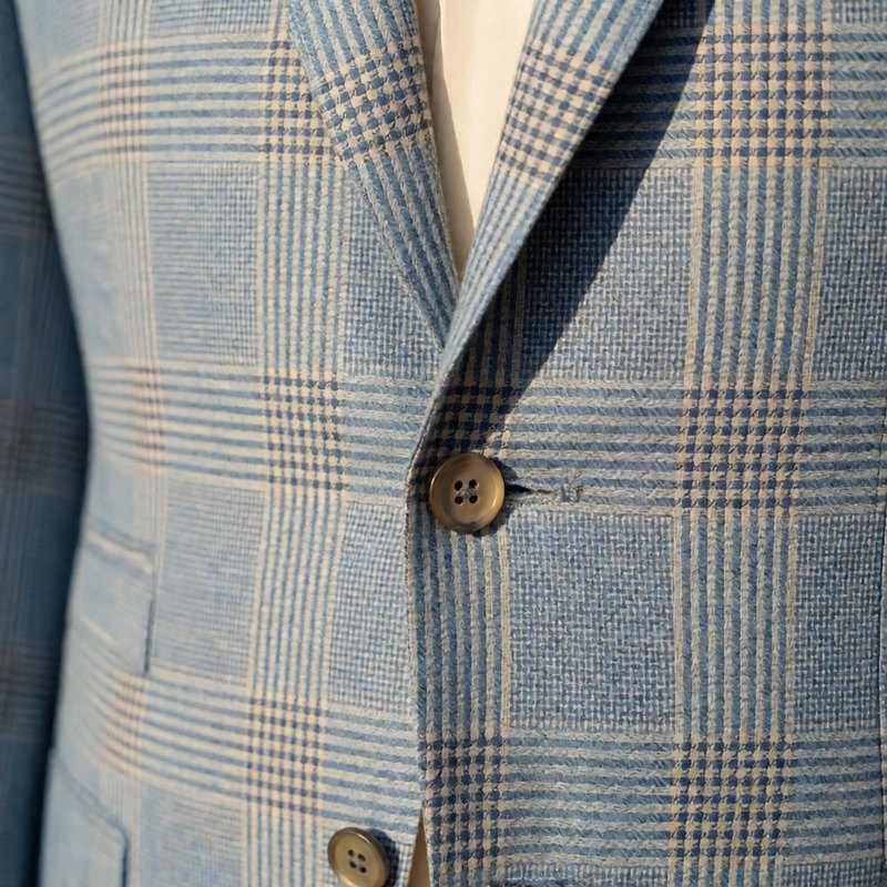 Close-up of the watercolor blue check pattern at lapel and button