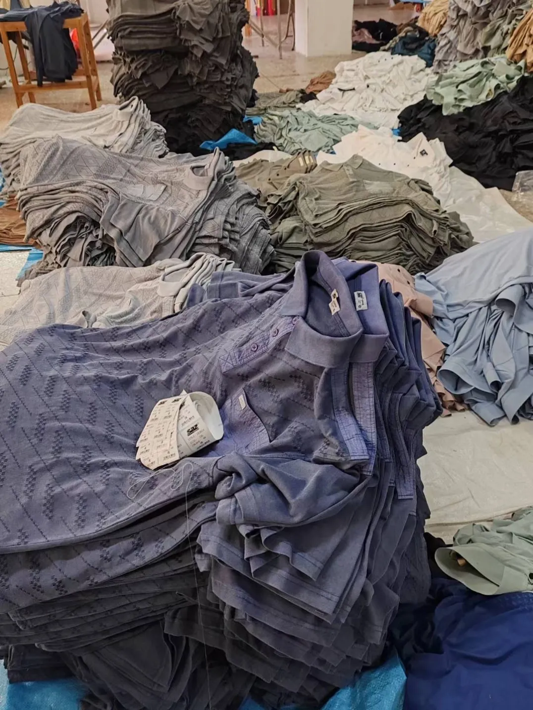 Bulk custom apparel packed in cartons on the factory floor