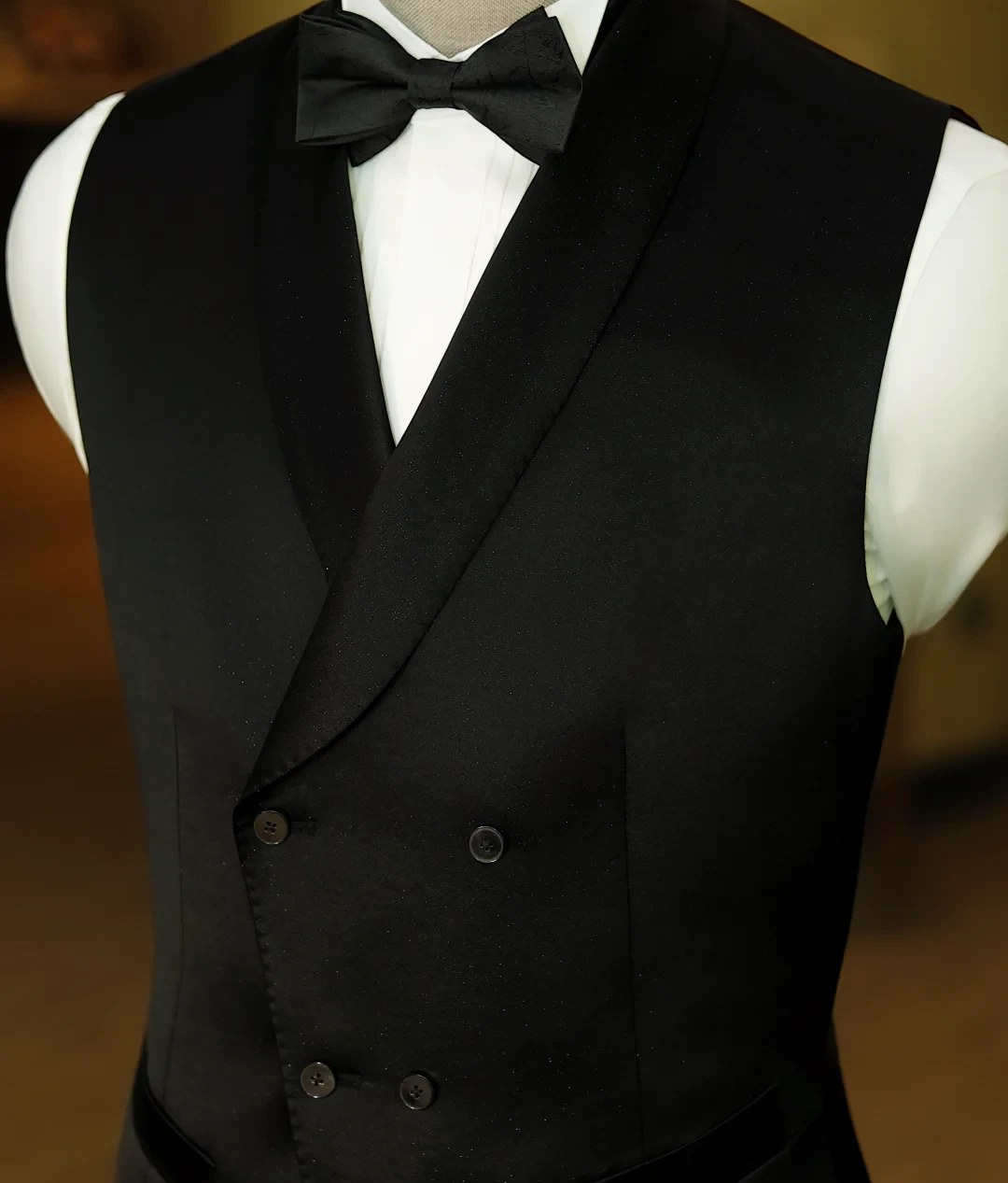 Black double-breasted vest with bow tie on mannequin